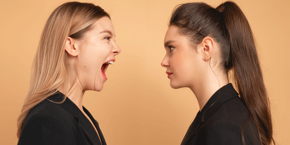Boss yelling at staff member face to face.